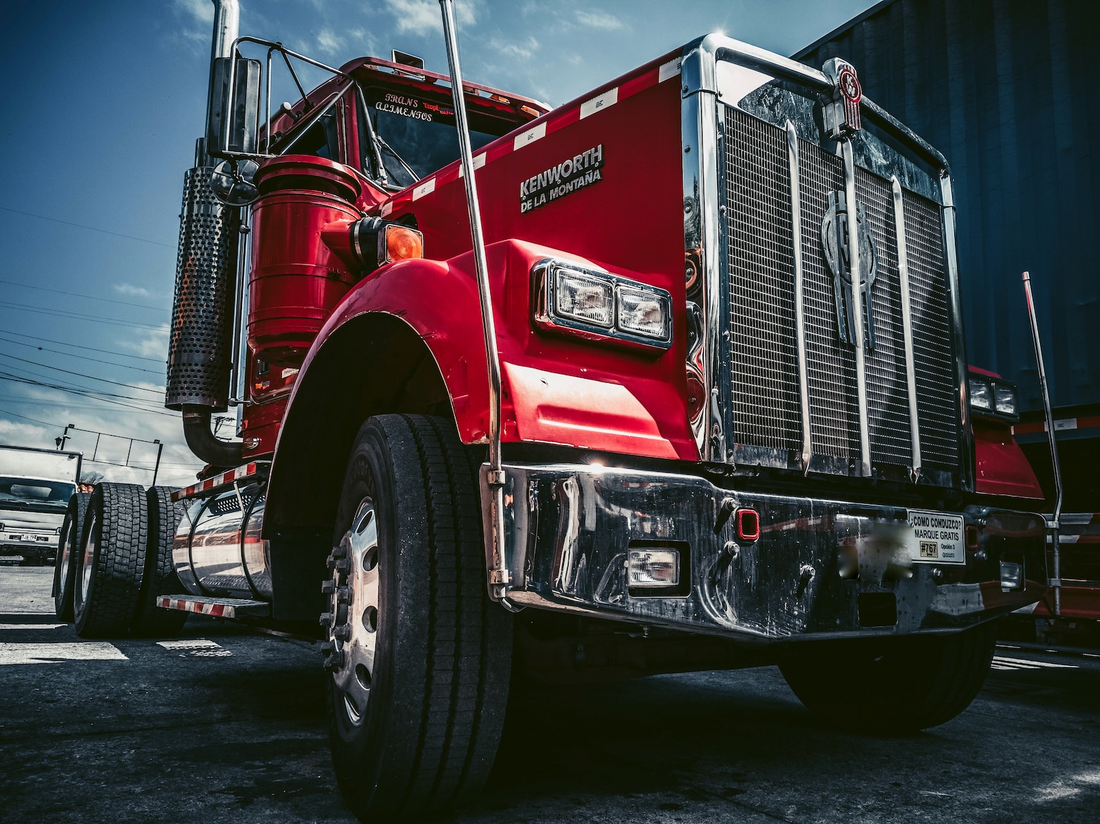 red and white truck on black asphalt road with trucking insurance coverage